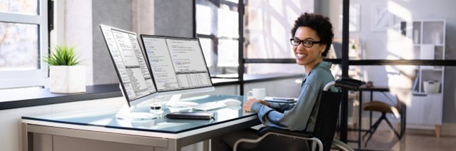 woman in wheelchair at desk